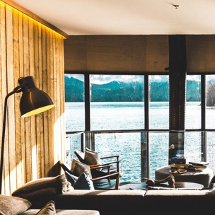inside of room overseeing lake through window